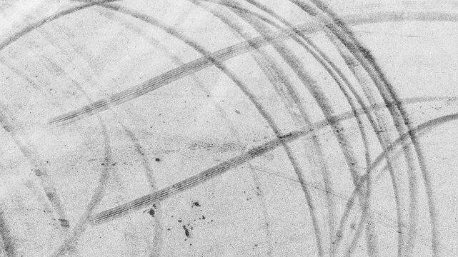 Aerial view abstract asphalt street road background with black tire marks on race track, Texture and background car automobile and automotive skid tire marks.