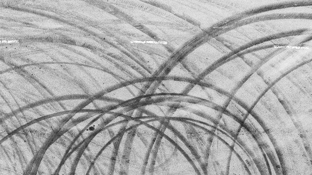 Aerial view abstract asphalt street road background with black tire marks on race track, Texture and background car automobile and automotive skid tire marks.