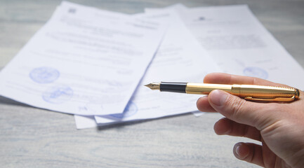 Pen and contract on the table.