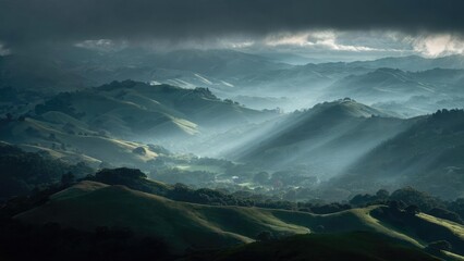 Dramatic valley of green rolling hills as sunbeams break through stormy clouds, misty layers stretching into the distance. Concept Dramatic valley landscape, Green rolling hills