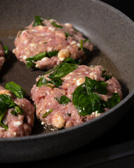 cooking raw turkey meatballs in a pan, healthy home meal