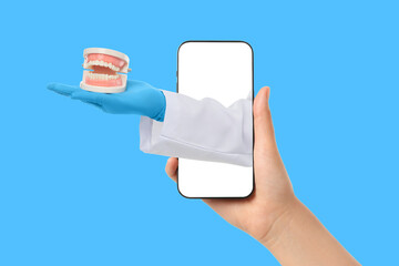 Doctor presents dental model while holding smartphone display