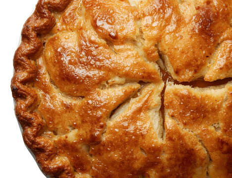 A freshly baked homemade apple pie with a perfectly golden and flaky crust isolated on a white background