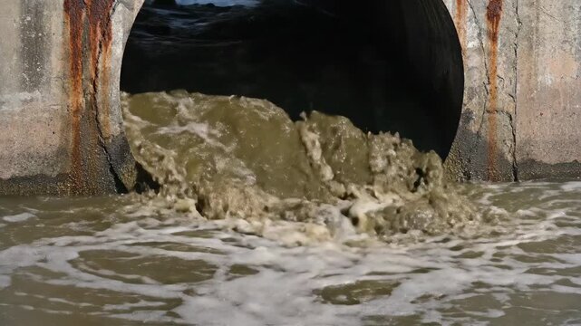 Effluent Flows From Drainage Pipe Into Body of Water