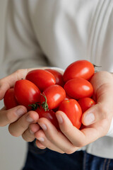 kid hands holding fresh bunch of cherry tomatoes, healthy eating concept