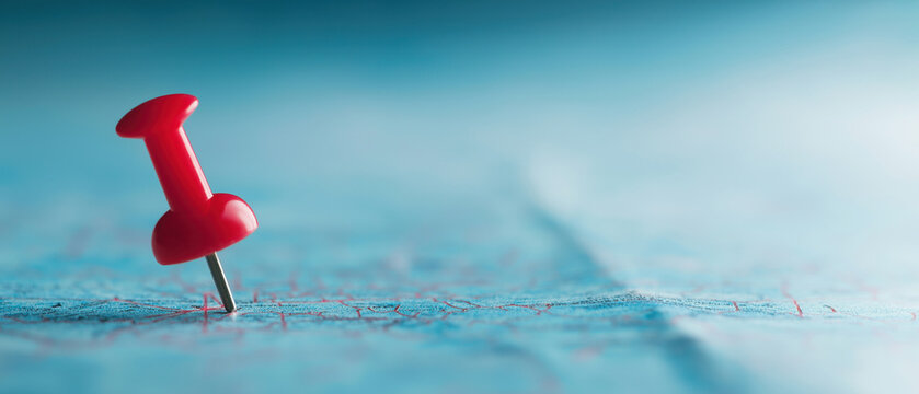 A red pushpin marks a spot on a blue map, created AI