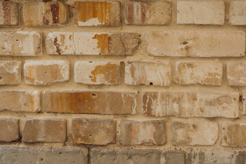 Aged beige brick wall with weather stains for rustic architecture and historic building concept