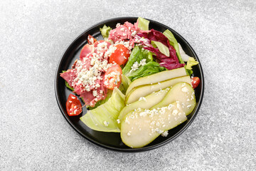 Healthy pear blue cheese salad on gray