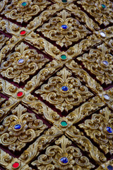 Golden Lanna-style Thai pattern panels decorated with gems for luxurious architecture and decoration.