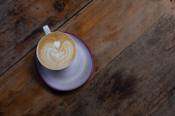 Cozy Latte With Heart Latte Art on Wooden Table in a Caf&eacute; Setting
