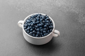 Blueberries in white ceramic bowl for superfood or health concept