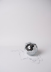 Silver disco ball on white background, space for text.