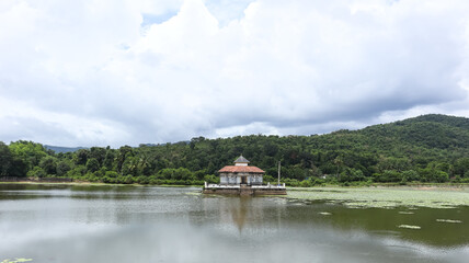 Obraz premium India, Karnataka, Udupi, View of Varanga Lake Jain Temple With Dramativ Clouds, the 14th Century Jain Temple Located in Centre of Lake.