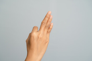 Close Up Of A Hand With Three Fingers Extended In A Studio Setting With Soft Lighting