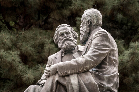 Karl Marx and Friedrich Engels monument sits in Bishkek&rsquo;s central park, symbolizing Soviet socialist ideology amid leafy Kyrgyz city surroundings.
