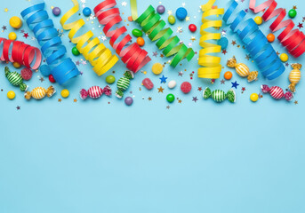 Colorful party streamers, candies, and confetti on a bright blue background