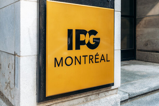 Montreal, Canada - August 14, 2025: IPG Montreal company signboard on yellow background, downtown office entrance