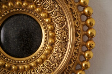 Fototapeta premium Ornate golden frame with dark center showcasing intricate details and luxurious design elements