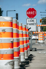 Montreal, Canada - August 14, 2025: Traffic barrels and stop sign at roadwork area near the Biodome