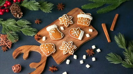 Christmas gingerbread cookies on wooden board with pine branches and cinnamon sticks - Powered by Adobe