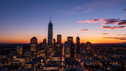 Vertical time-lapse of a modern city skyline at sunset. The sun sets behind tall skyscrapers as the city lights turn on. Day to night transition of an urban metropolis - Powered by Adobe