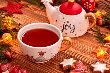 Tea cup, cookies and Christmas ornnaments on wooden table
