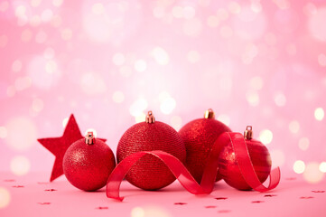 Red Christmas decorations on pink background