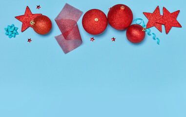 Christmas baubles, stars and ribbons on blue background