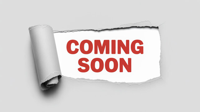 Coming soon announcement revealed through torn paper effect on a gray background