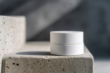 Mockup of a single white matte cosmetic jar standing on a rough concrete step or staircase outdoors. Strong light, sharp shadow. Minimalist skincare packaging, modern aesthetic. Copy space.