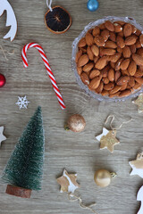 Obraz premium Various Christmas decorations, cookies, chocolate and nuts on wooden background. Flat lay.