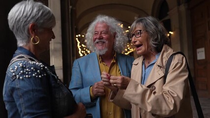 Happy senior friends talking and laughing together outdoors - Powered by Adobe