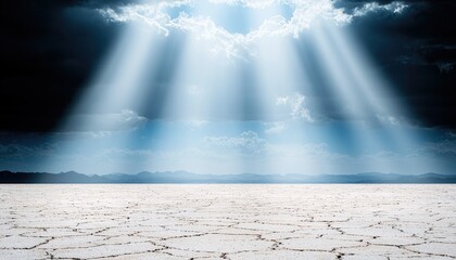 Sunlight streams through dramatic clouds onto a barren, cracked earth landscape with distant mountains under a moody sky.