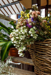 bouquet of dried flowers in a wicker basket on the stairs