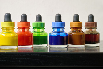 Indoor. Small bottles of colored watercolors