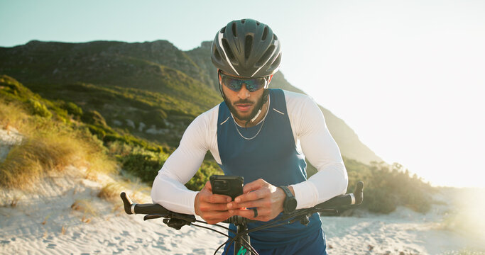 Fitness, cyclist and man with phone in nature for networking, chatting or connectivity with training. Sports, cycling and athlete with cellphone for texting, communication or contact on mobile app.