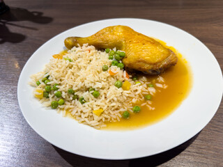 Delicious chicken with rice and vegetables on a plate