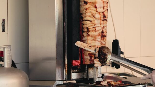 Grilled meat close up footage. Cooking traditional Turkish kebab meat doner, shawarma or gyros. High quality 4k footage