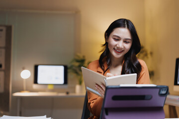 Young woman studying online, video calling with tablet