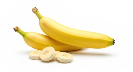 Two whole, ripe bananas next to several slices