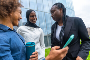 Diverse business people talking outdoors during work break