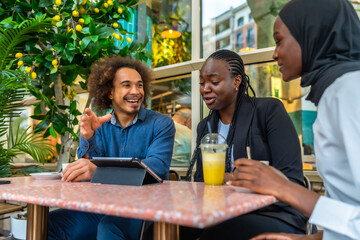 Diverse friends discussing ideas during a casual cafe meeting