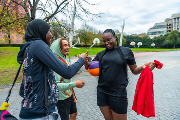 Diverse friends high fiving before playing basketball