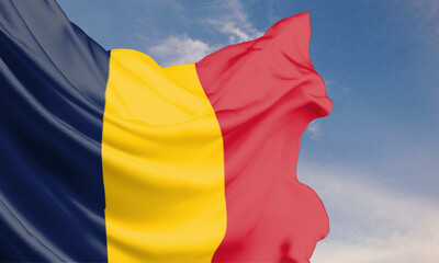The Chad flag waving in the blue sky on a flagpole, celebrating Independence Day with the national emblem on flowing fabric.