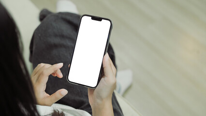 Close up view of a woman using blank screen smartphone