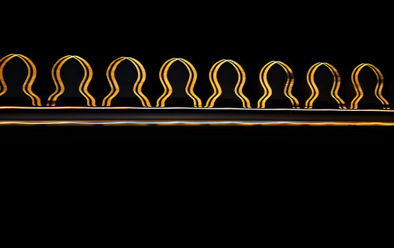 Abstract golden light trails with repeating curved wave pattern on black background