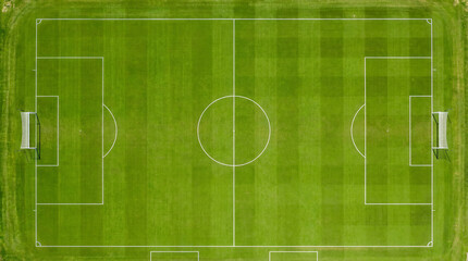  aerial view of a soccer field capturing the dynamic action of players running, passing, and scoring goals. 