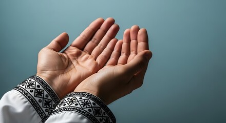 Hands raised in prayer and supplication against a blue background