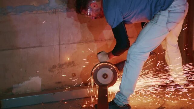 professional using angle grinder to cut metal safely and precisely, skilled worker operating angle grinder to carefully cut steel bar against concrete background
