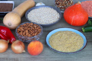 Assortment of various healthy fruits, vegetables, grains and legumes. Selective focus, wooden background.